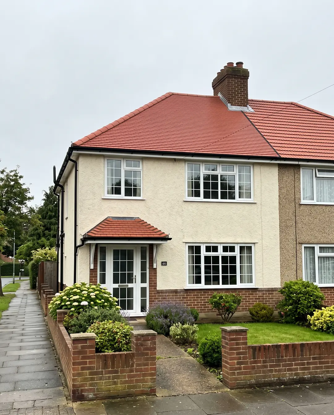 A 1930s semi-detached house with a newly tiled red clay roof